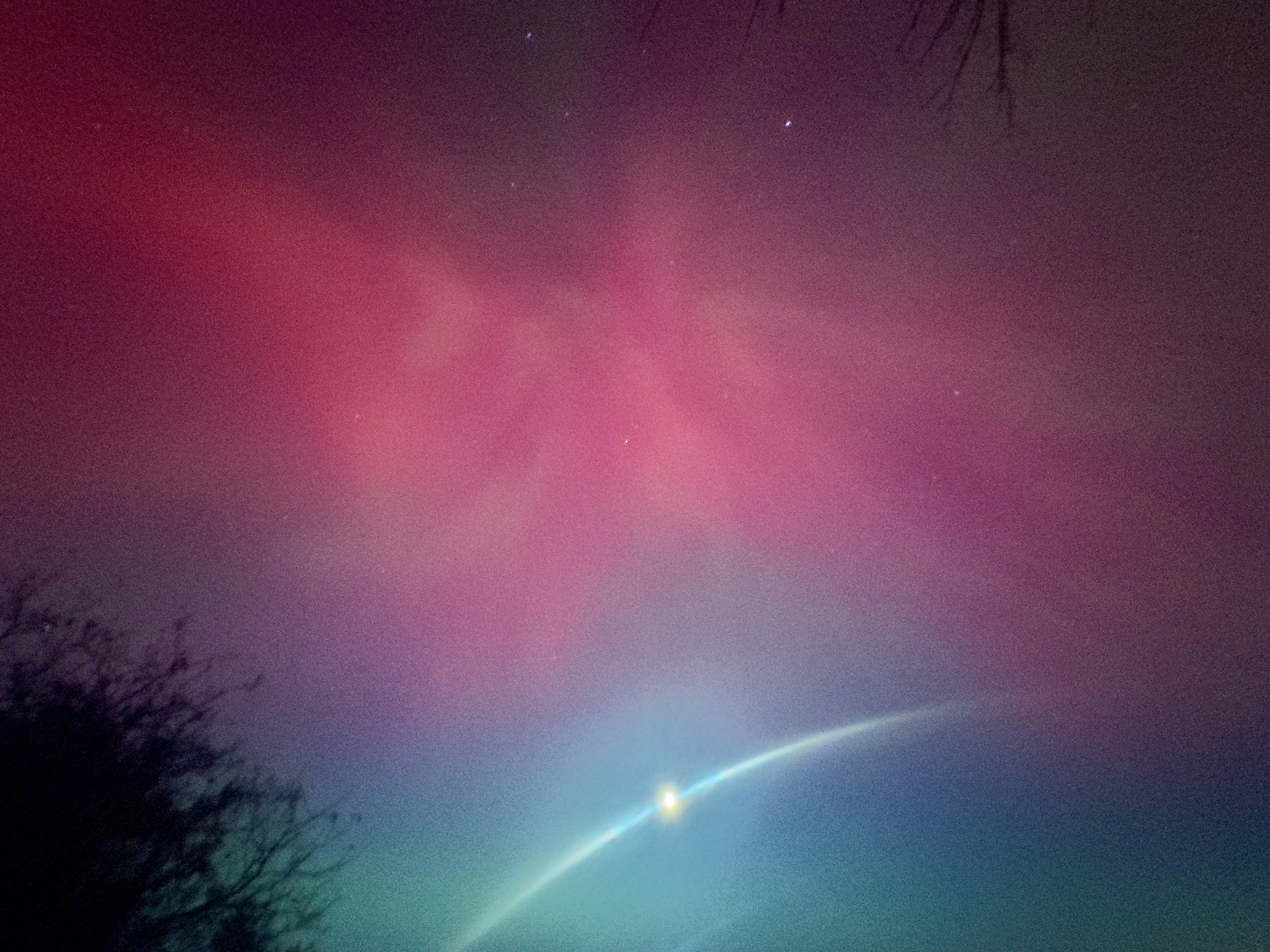 Aurora over a dark landscape.